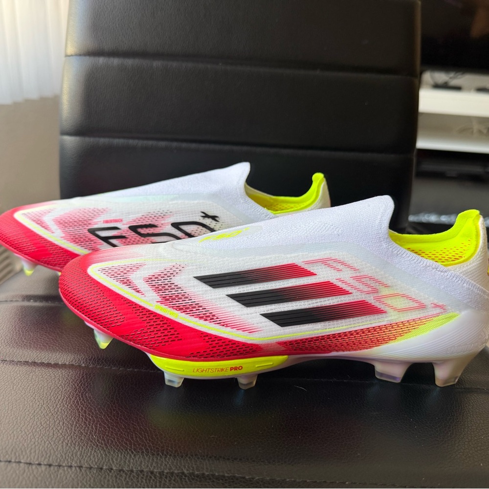 Adidas White and Red Soccer Cleats with Neon Accents